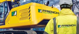 Ffrench manager in front of large caterpillar construction vehicle