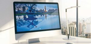 View of an office with the Lonic website displayed on a MAC PC